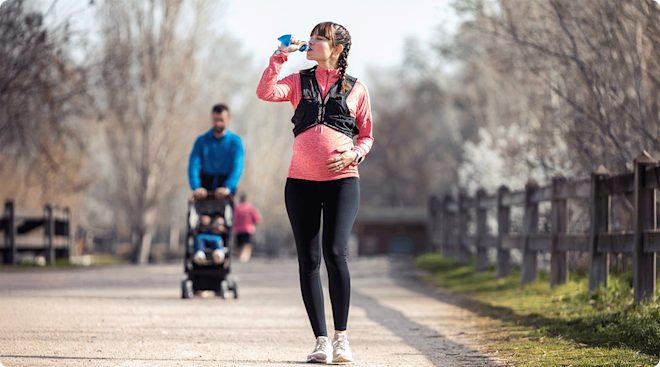 pregnant woman walking for exercise outside