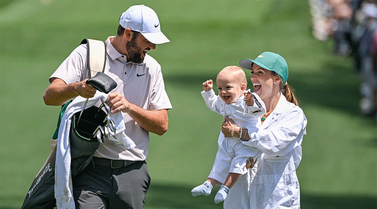 Scottie Scheffler and his wife Meredith Scheffler laughing with their son Bennett during the 2025 Masters Par Three Contest