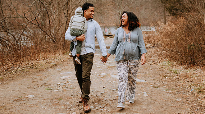 couple walking, expectant mom and partner with toddler