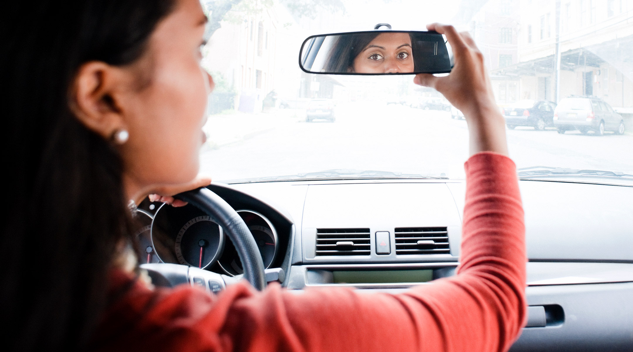 mom in car looking at rearview mirror