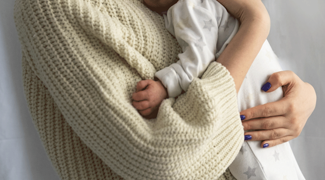 mother holding newborn baby