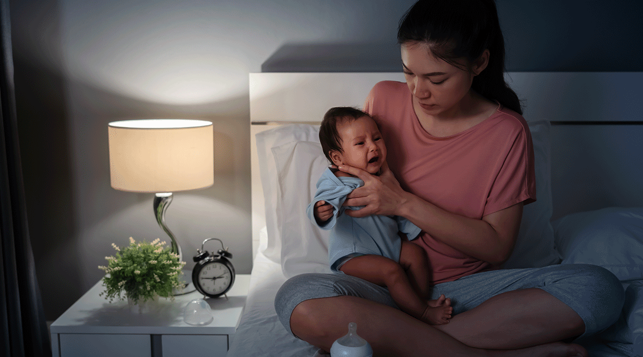 mom comforting crying baby at night