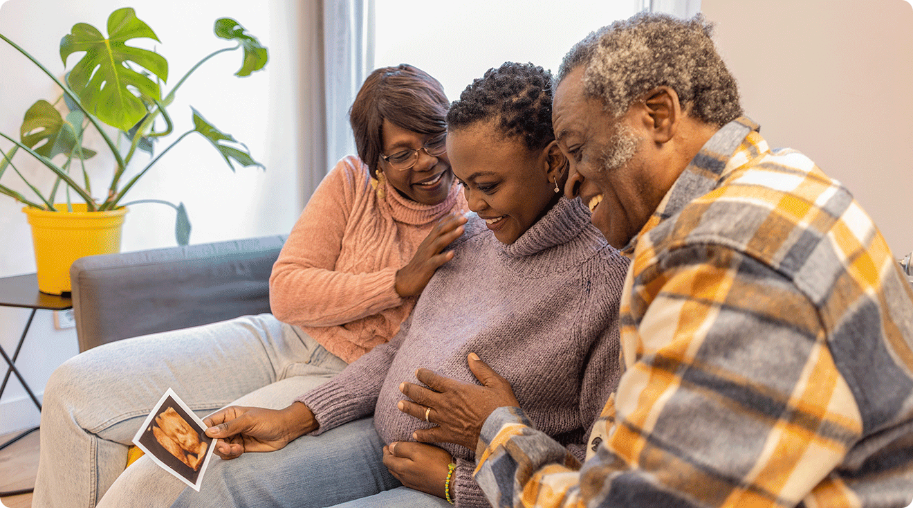 pregnant woman sitting with her parents soon to be grandparents