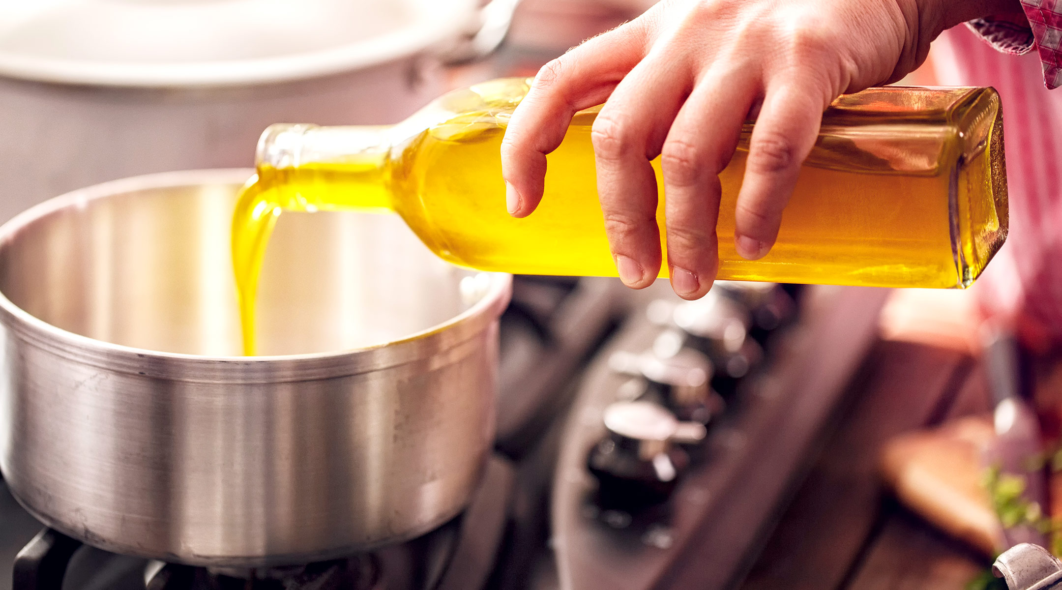 woman cooking with olive oil