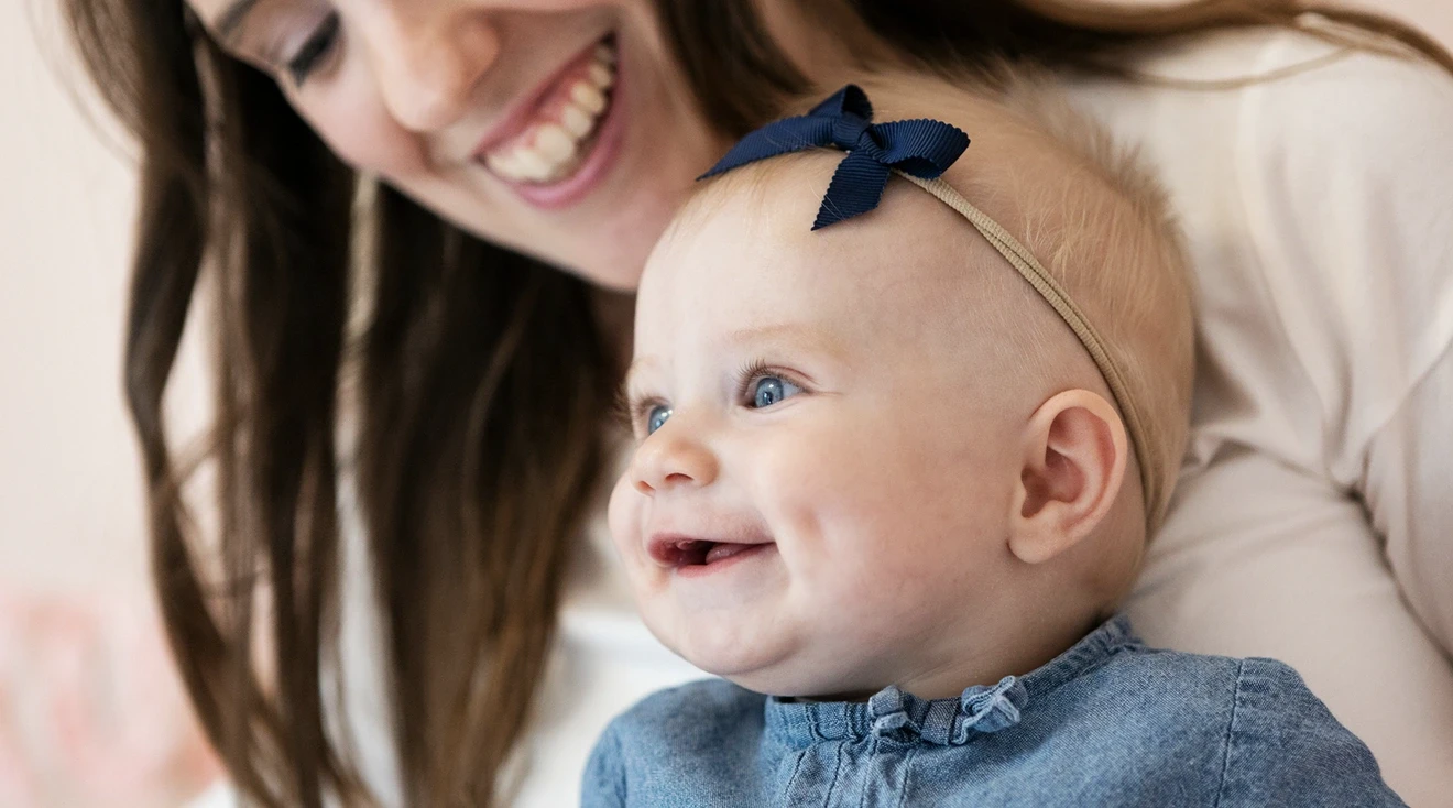 mother and baby smiling