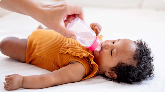 baby drinking water from baby bottle