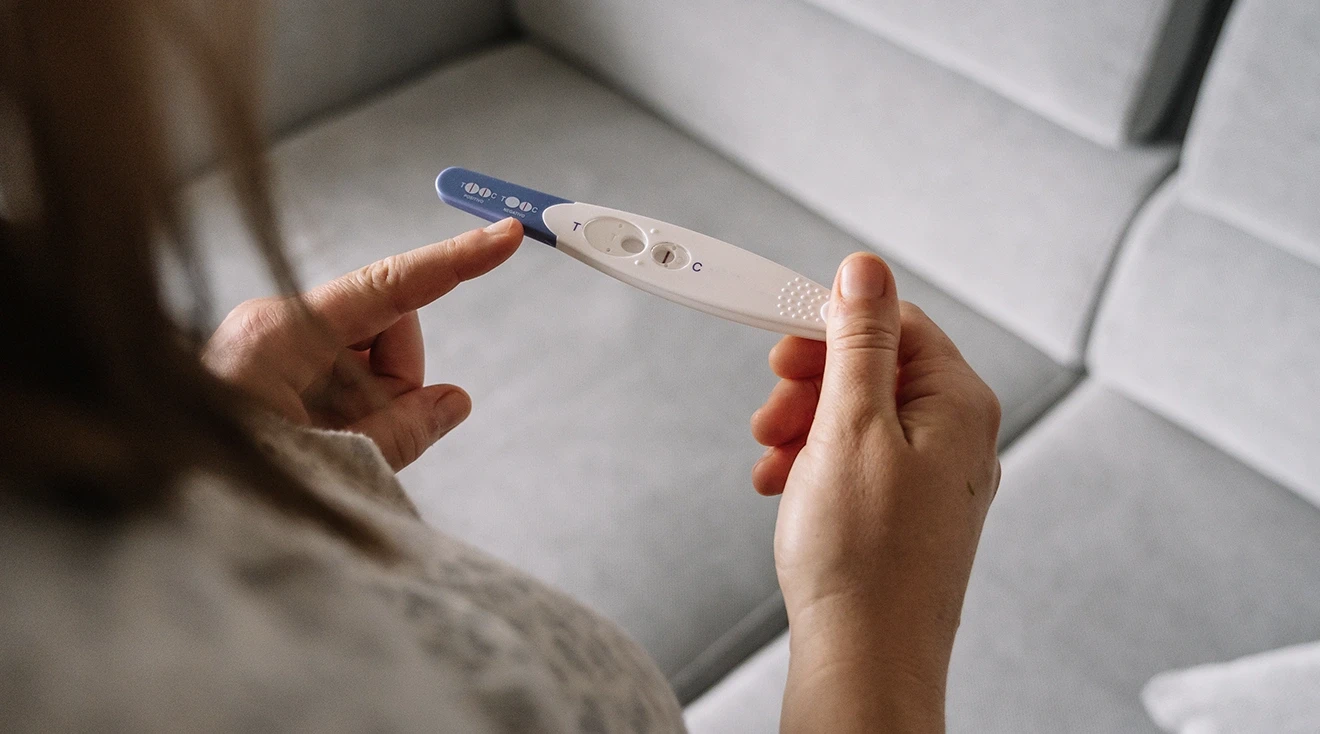 close up of woman holding negative pregnancy test