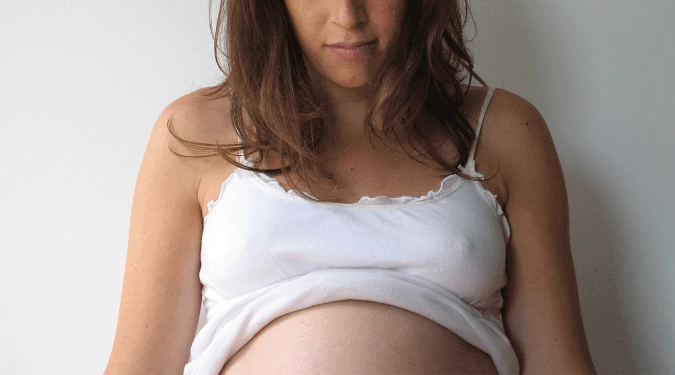 A woman is buttoning her underwear