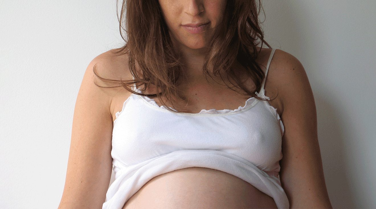 pregnant woman wearing white tank top; darkening areolas