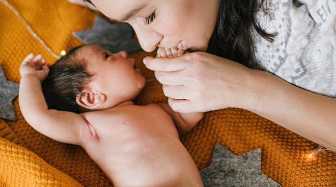 mom kissing baby's hand