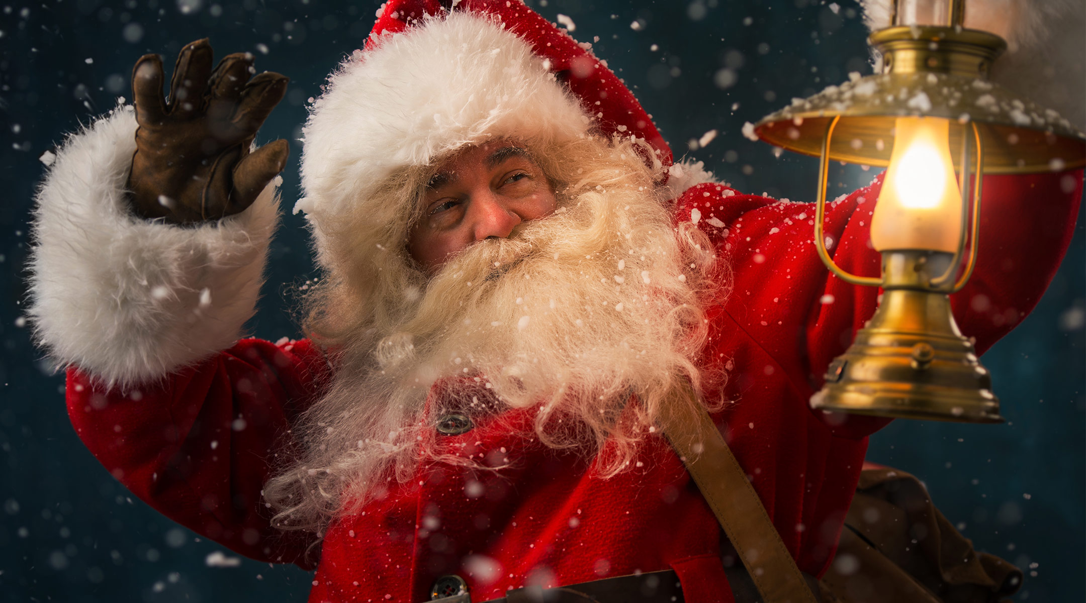 santa clause holding up a lantern