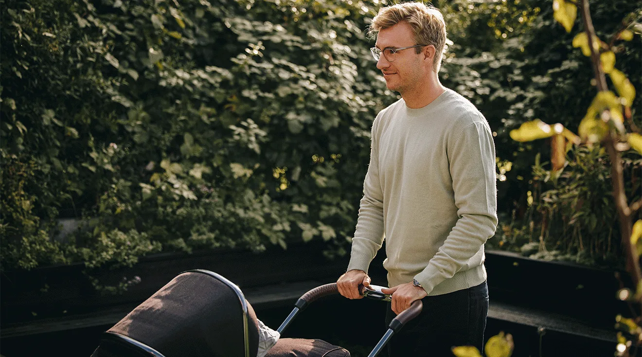 smiling dad pushing baby stroller