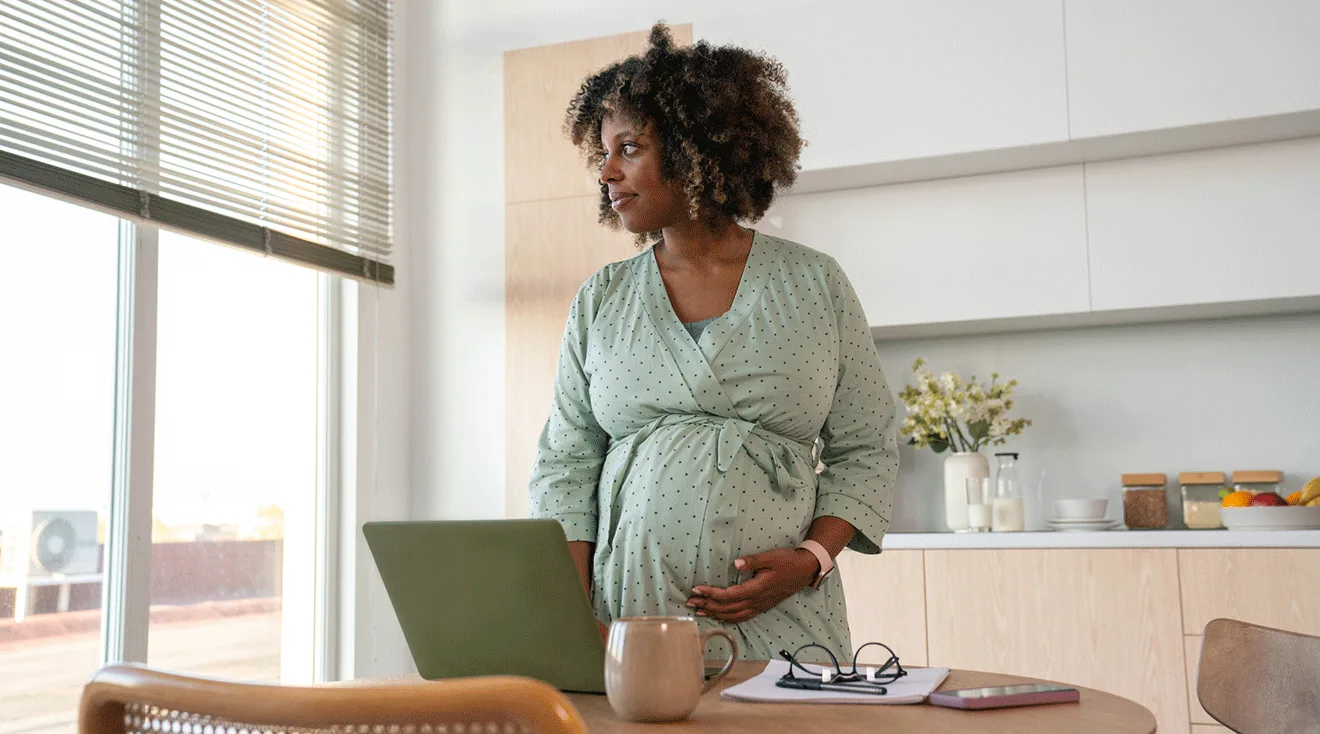 pregnant woman sitting on bed