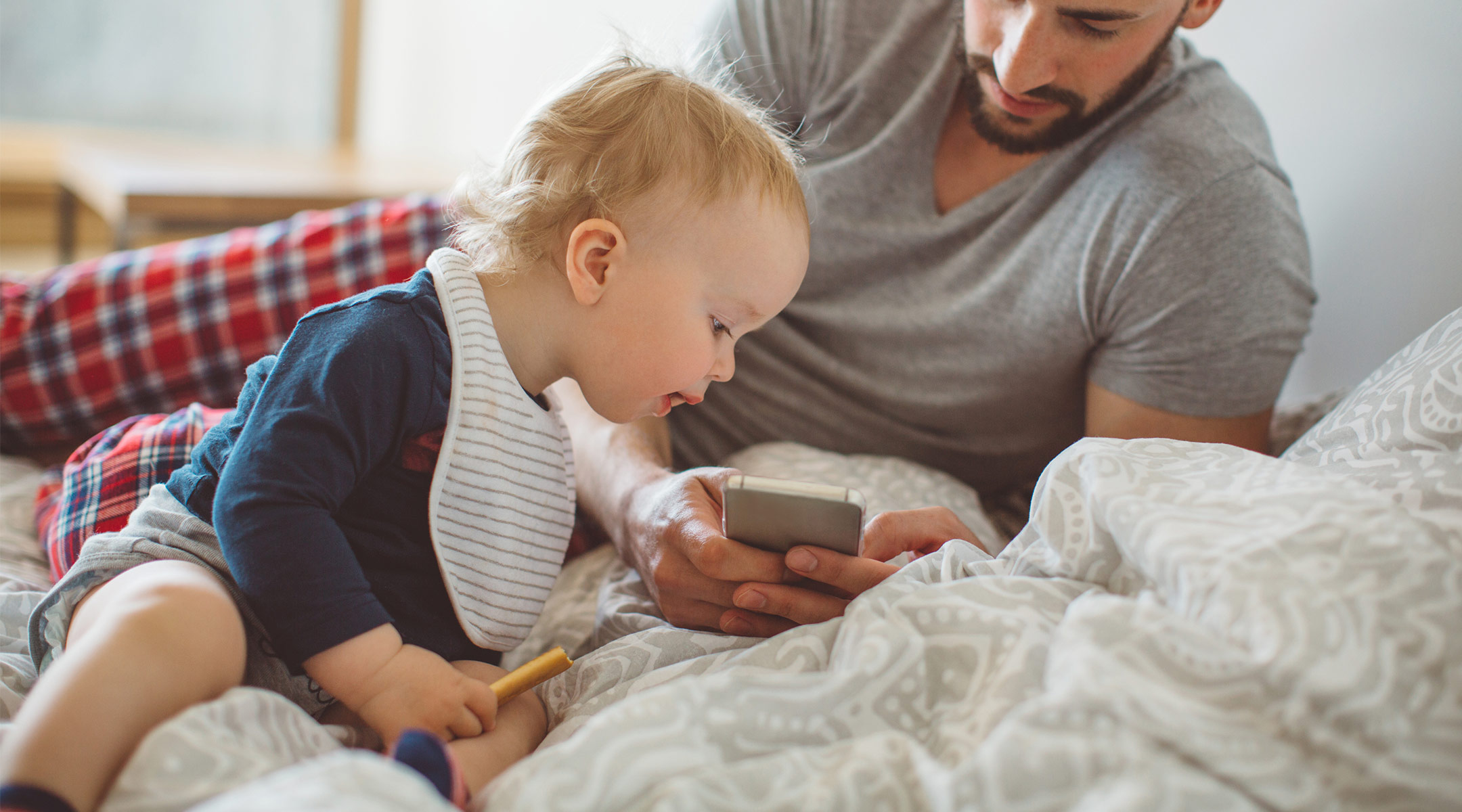 baby plays with dad's phone