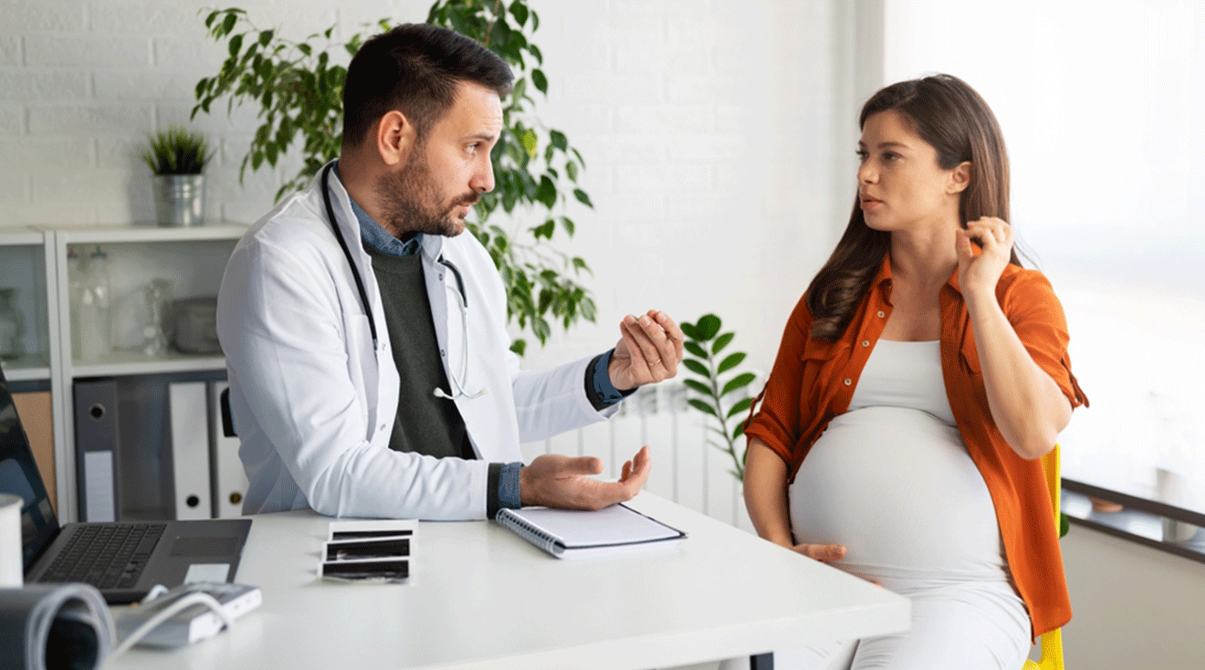 pregnant woman talking to doctor