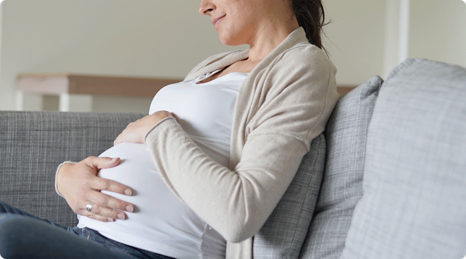 pregnant woman sitting on sofa