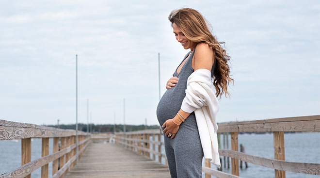 image of the author, pregnant standing on a dock