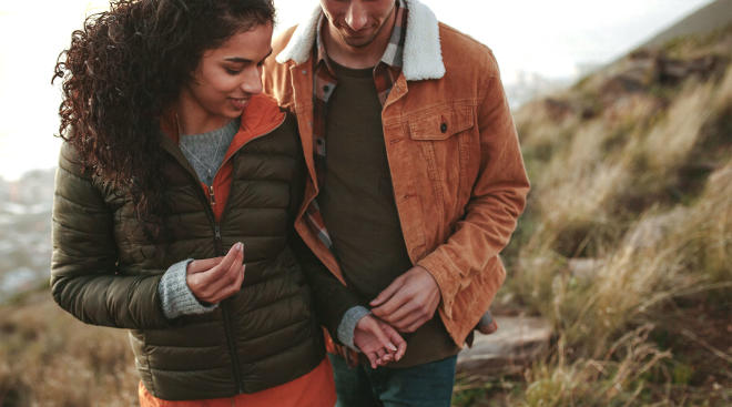 happy couple hiking closely together
