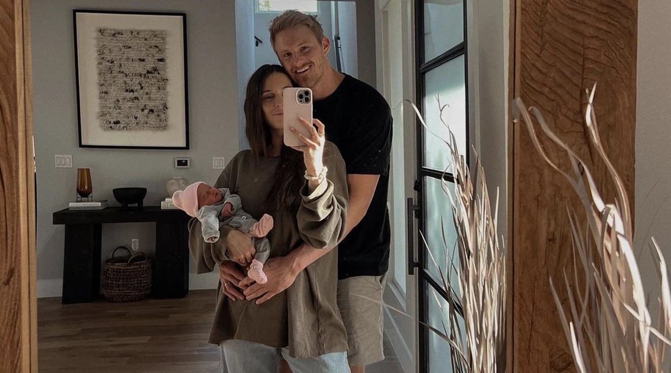 Alexander Ludwig and Wife Lauren holding their newborn baby at home