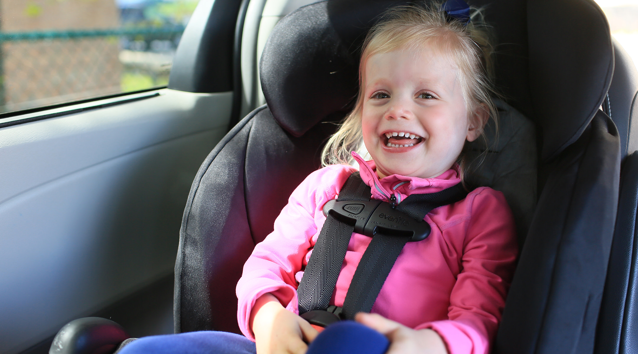 Girl sitting in a convertible car seat