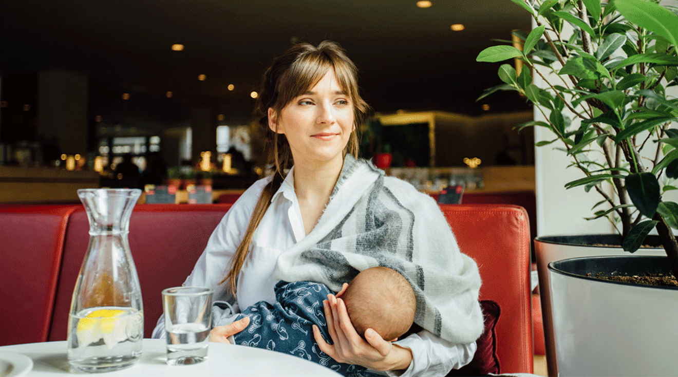 mother breastfeeding baby at restaurant