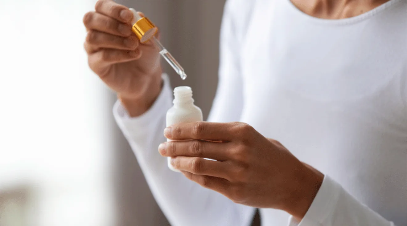 woman holding bottle of retinol skincare serum