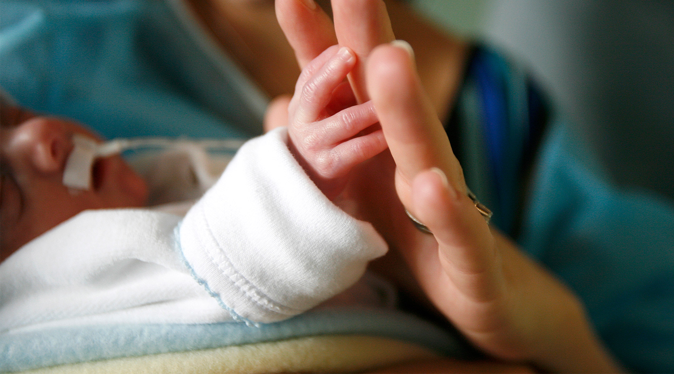 preemie baby being held at hospital