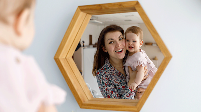 mom and baby looking in the mirror
