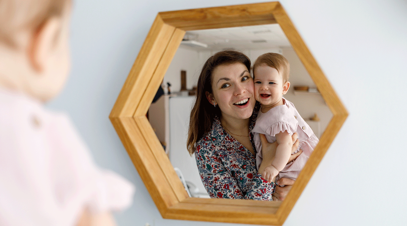 mom and baby looking in the mirror