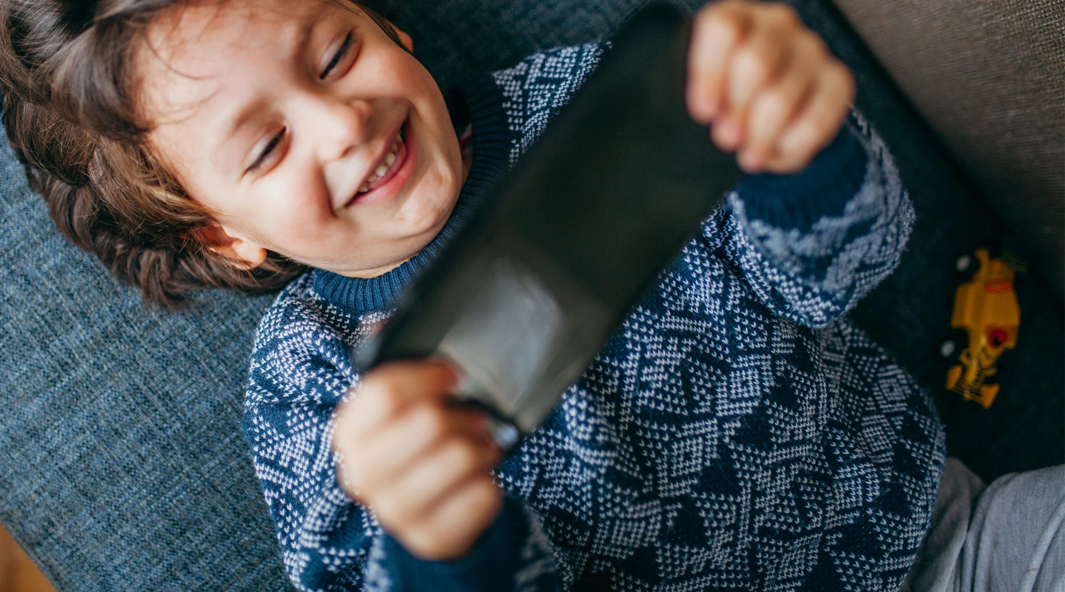 happy kid playing with app on phone