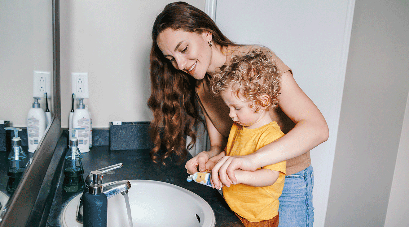 mom and toddler brushing teeth in bathroom