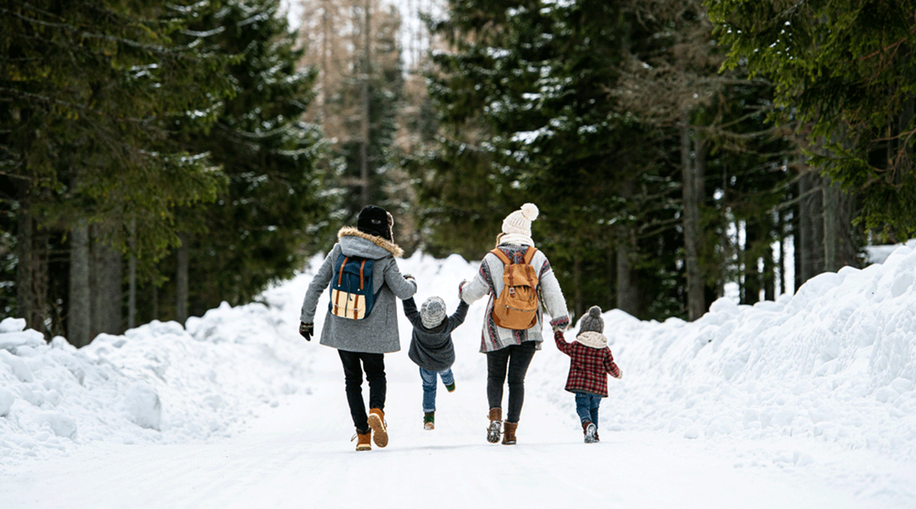 family walking in the snow