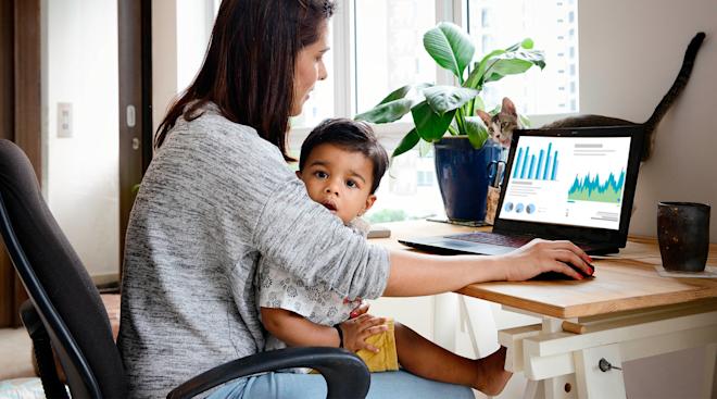 mom working with toddler on her lap