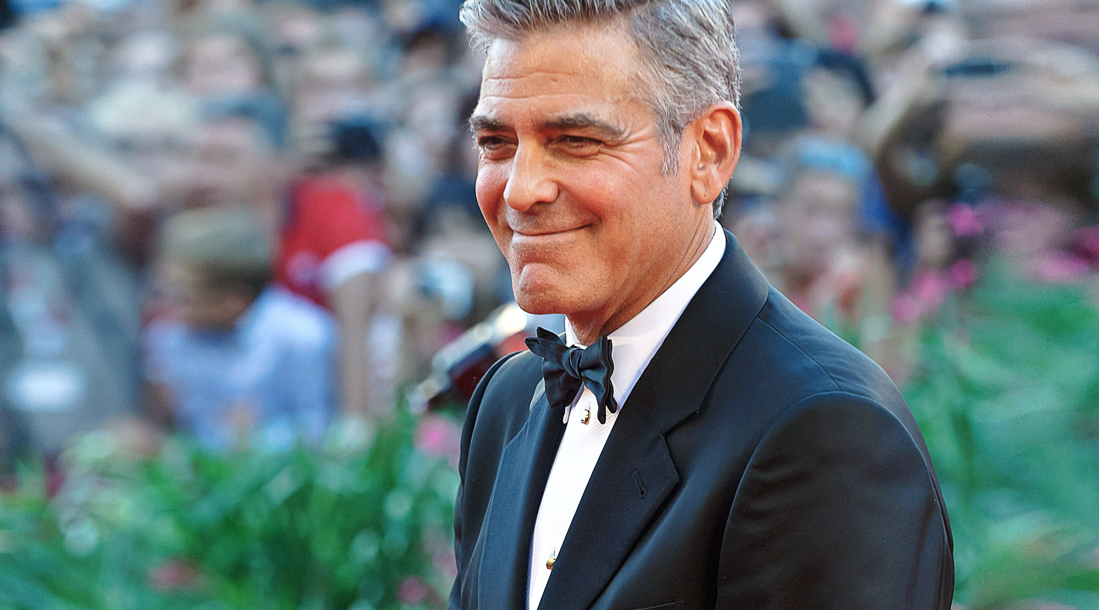 actor george clooney walks the red carpet