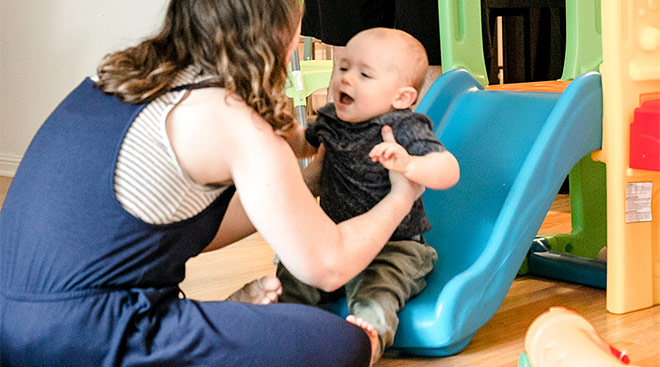 baby going down slide indoors