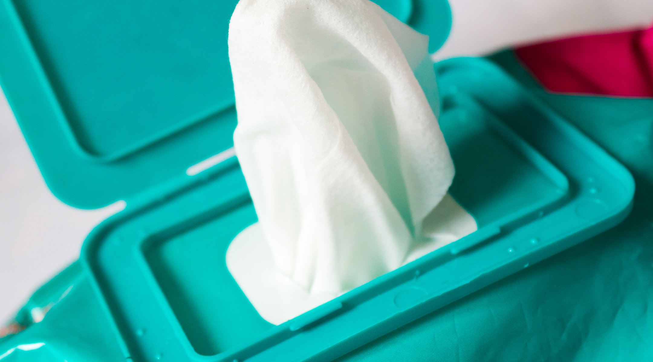 teal container of baby wipes