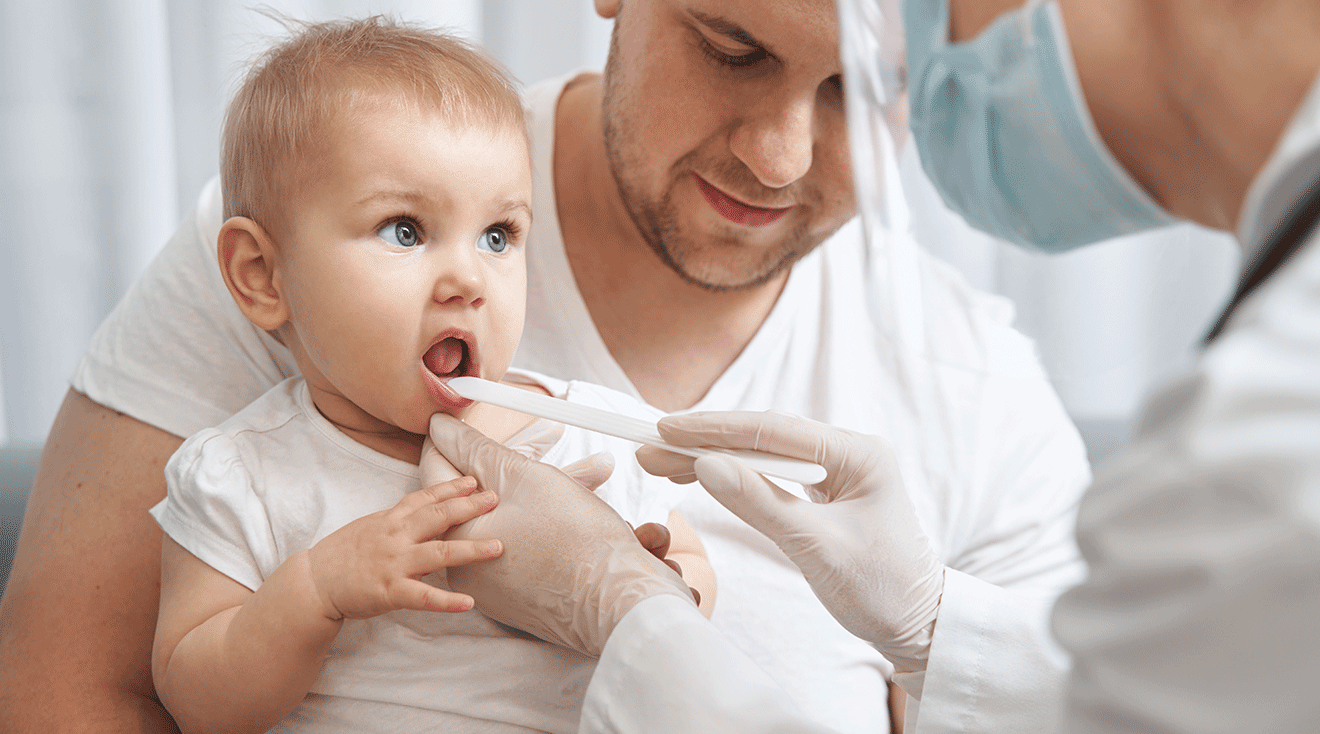 doctor checking baby's throat