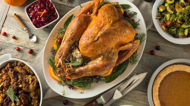 table with thanksgiving turkey and other foods