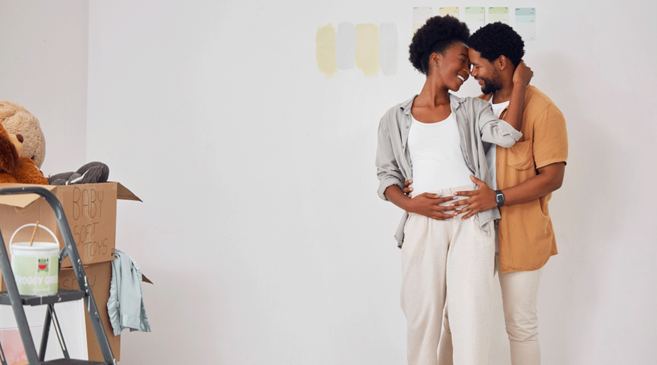 pregnant couple decorating baby's nursery