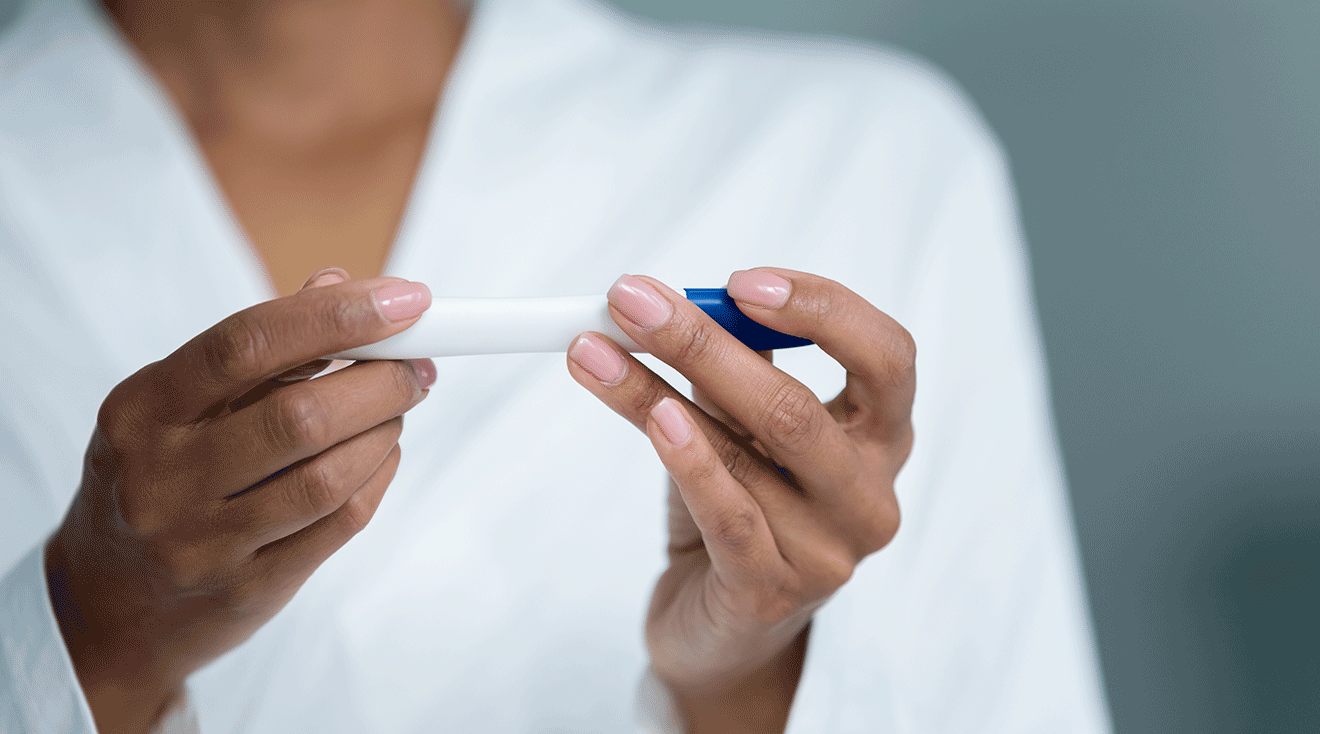 woman holding a pregnancy test close up