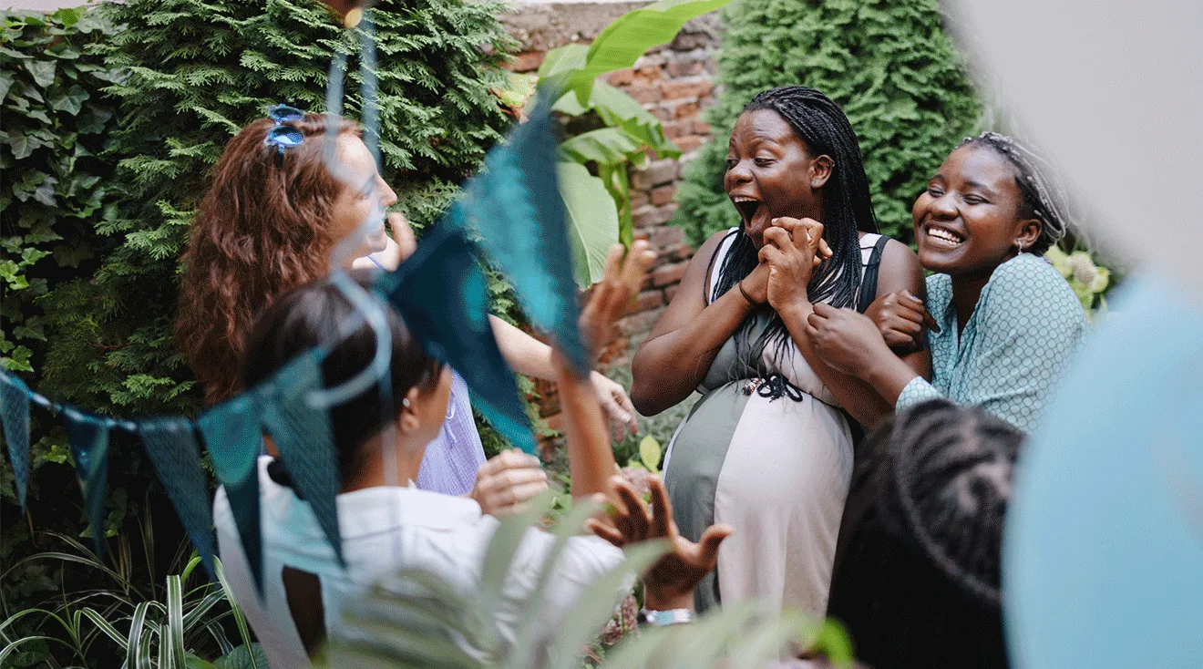 group of women having fun at baby shower party