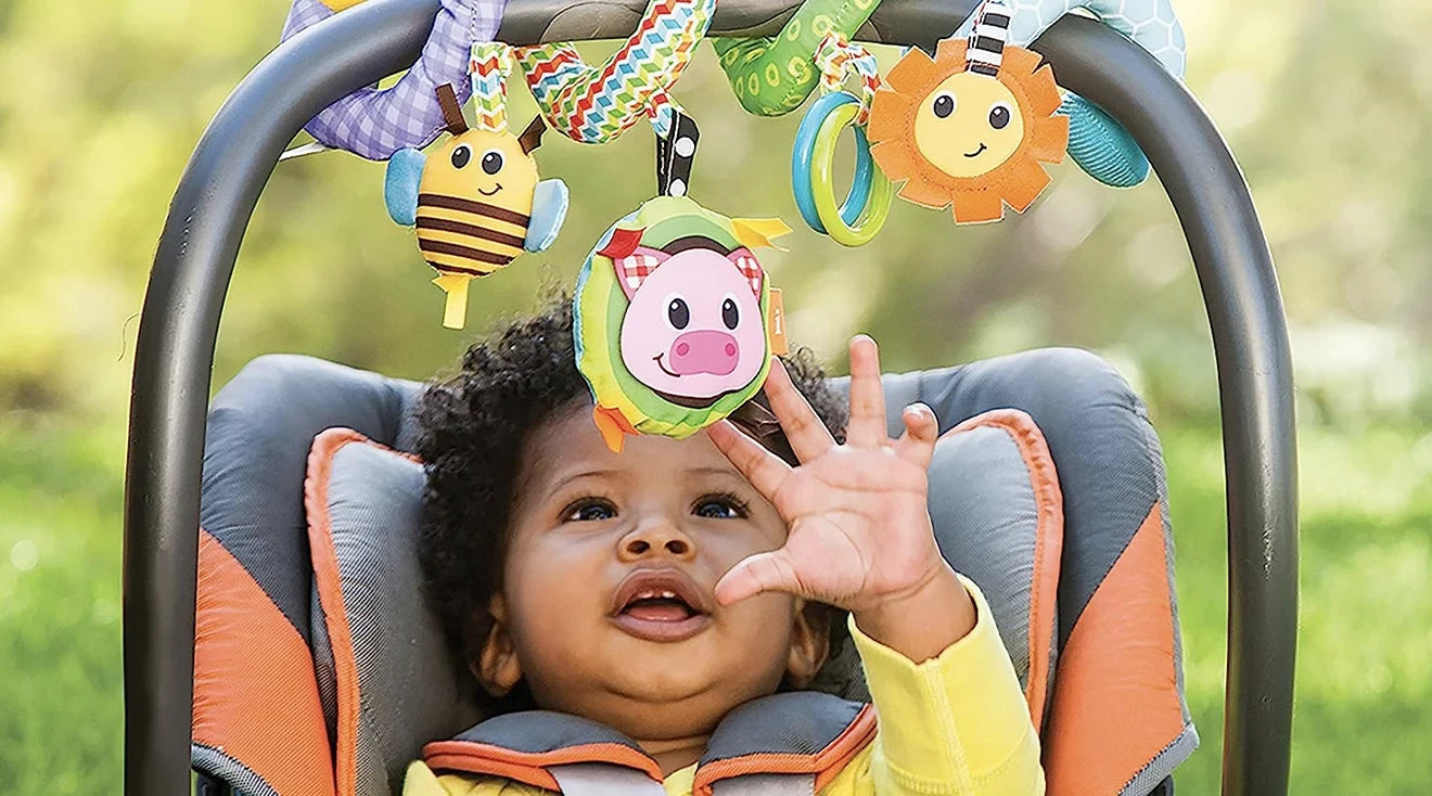 Baby playing with a stroller toy