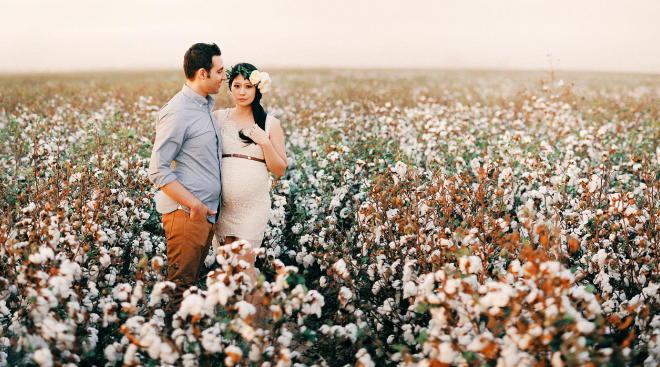 maternity shoot couple floral crown field