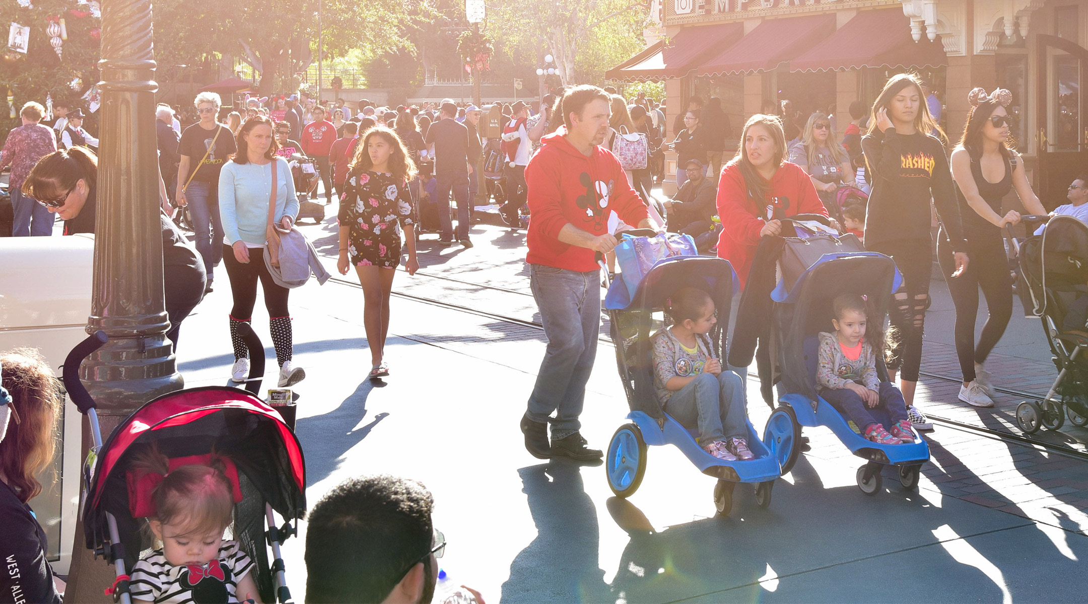 families at disney walking with strollers
