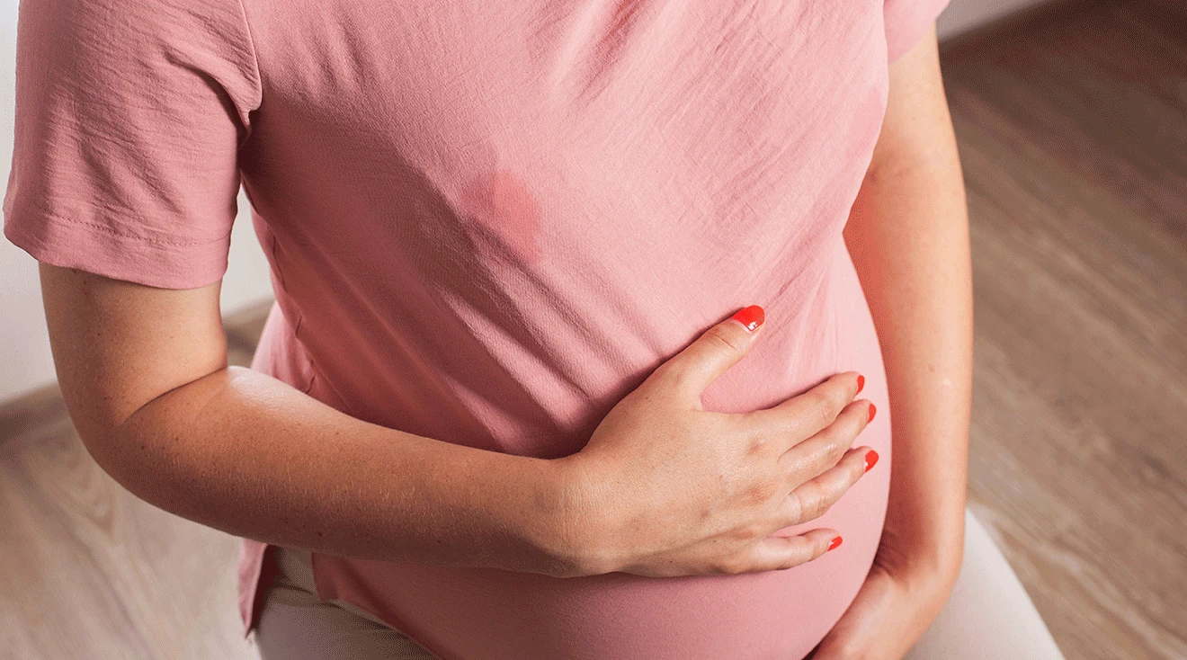 pregnant woman with milk stain on shirt