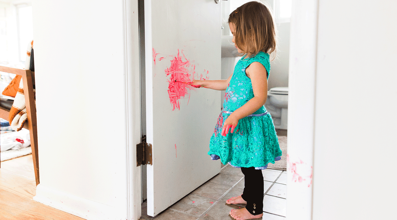 toddler painting on bathroom door