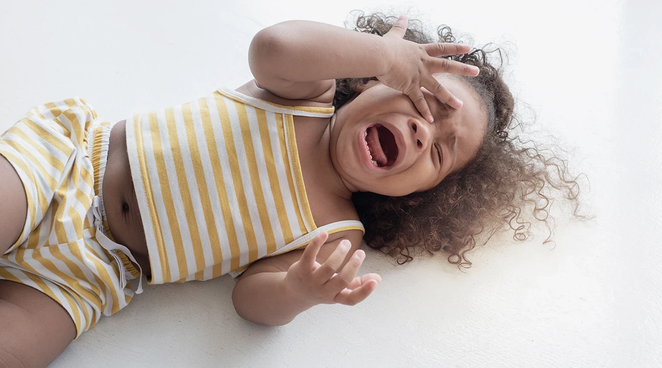 child throwing tantrum on floor