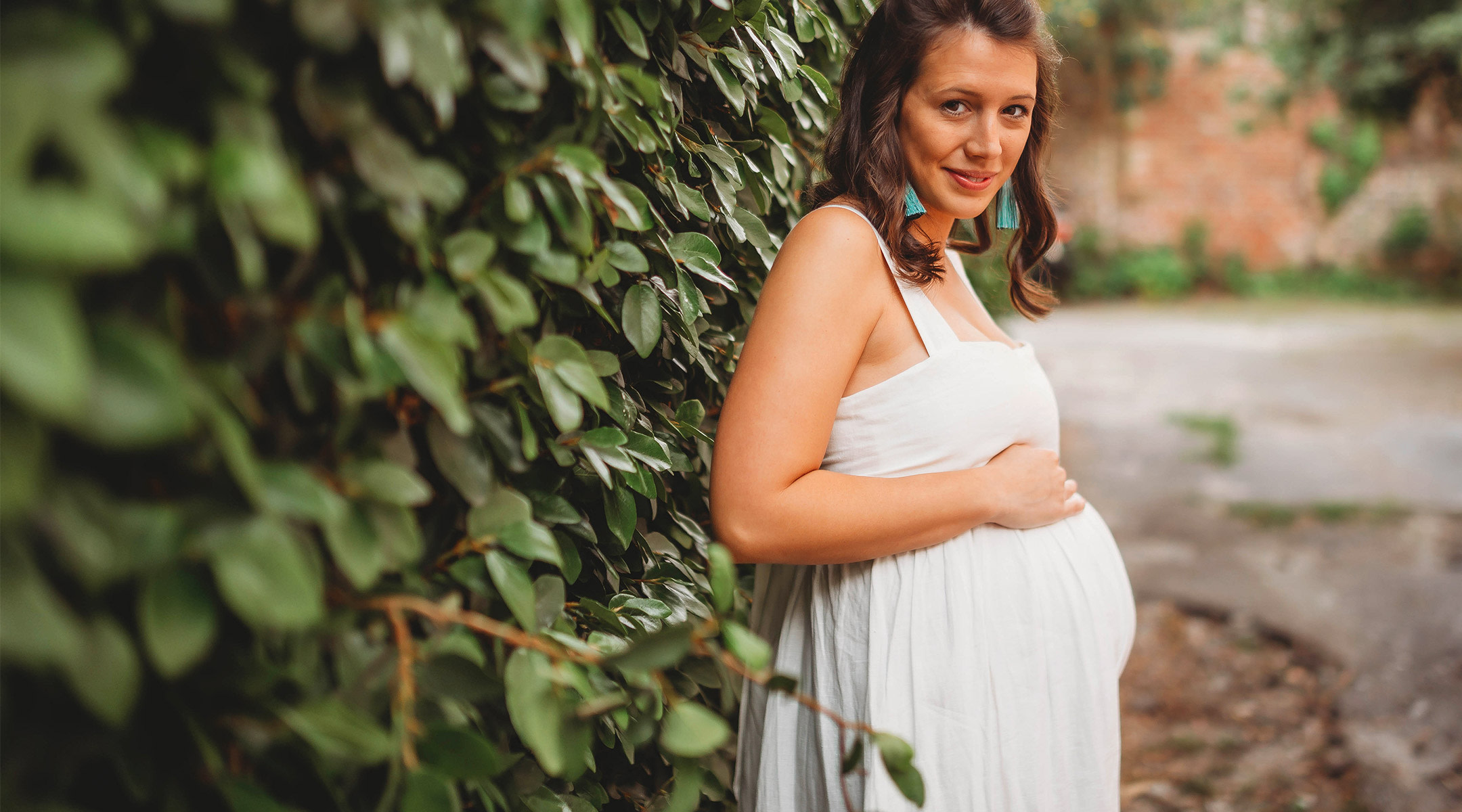 happy, calm pregnant woman smiling outside