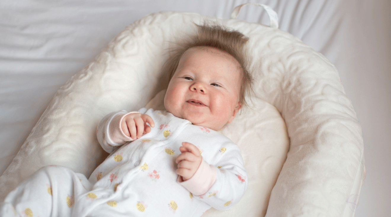 smiling baby in infant lounger