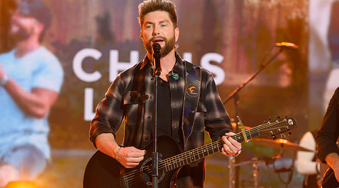 Country singer Chris Lane performing on stage at a concert. 